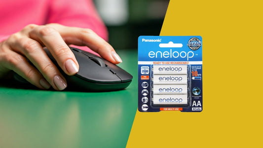 person using a mouse on green table and 4 pack of eneloop AA rechargeable batteries